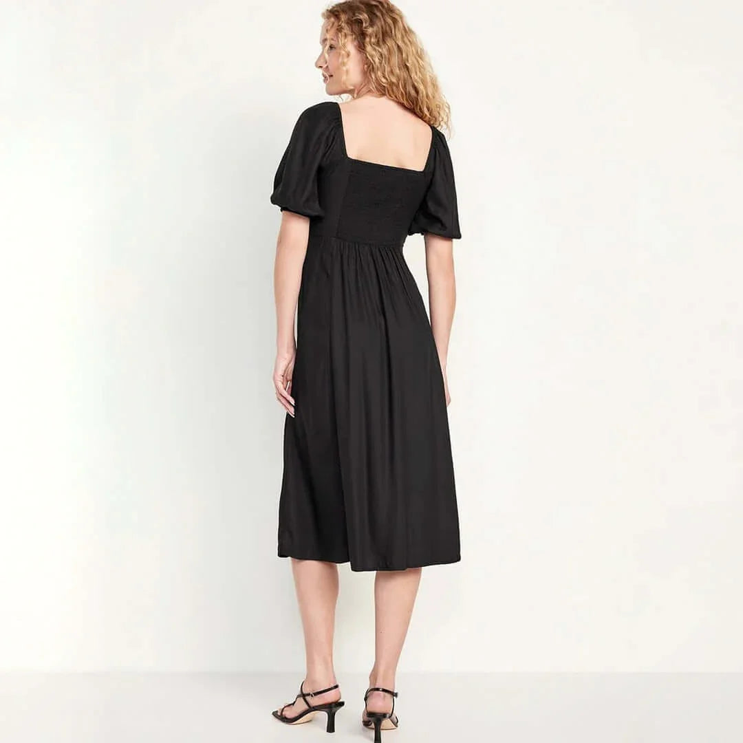 Back view of a model wearing an Old Navy fit and flare crepe midi dress in black, showcasing its relaxed style.